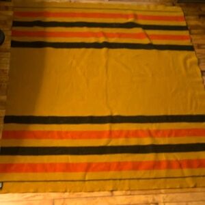 Hermes mustard background with red and black striped throw blanket